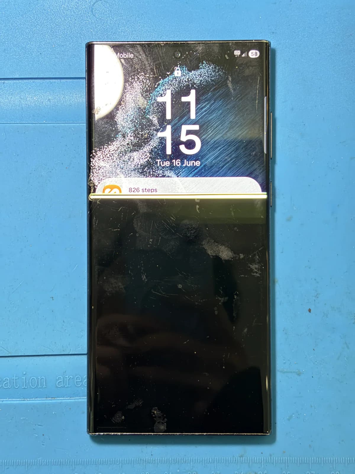 Galaxy S22 Ultra before screen replacement showing a bright horizontal line and blacked-out lower display
